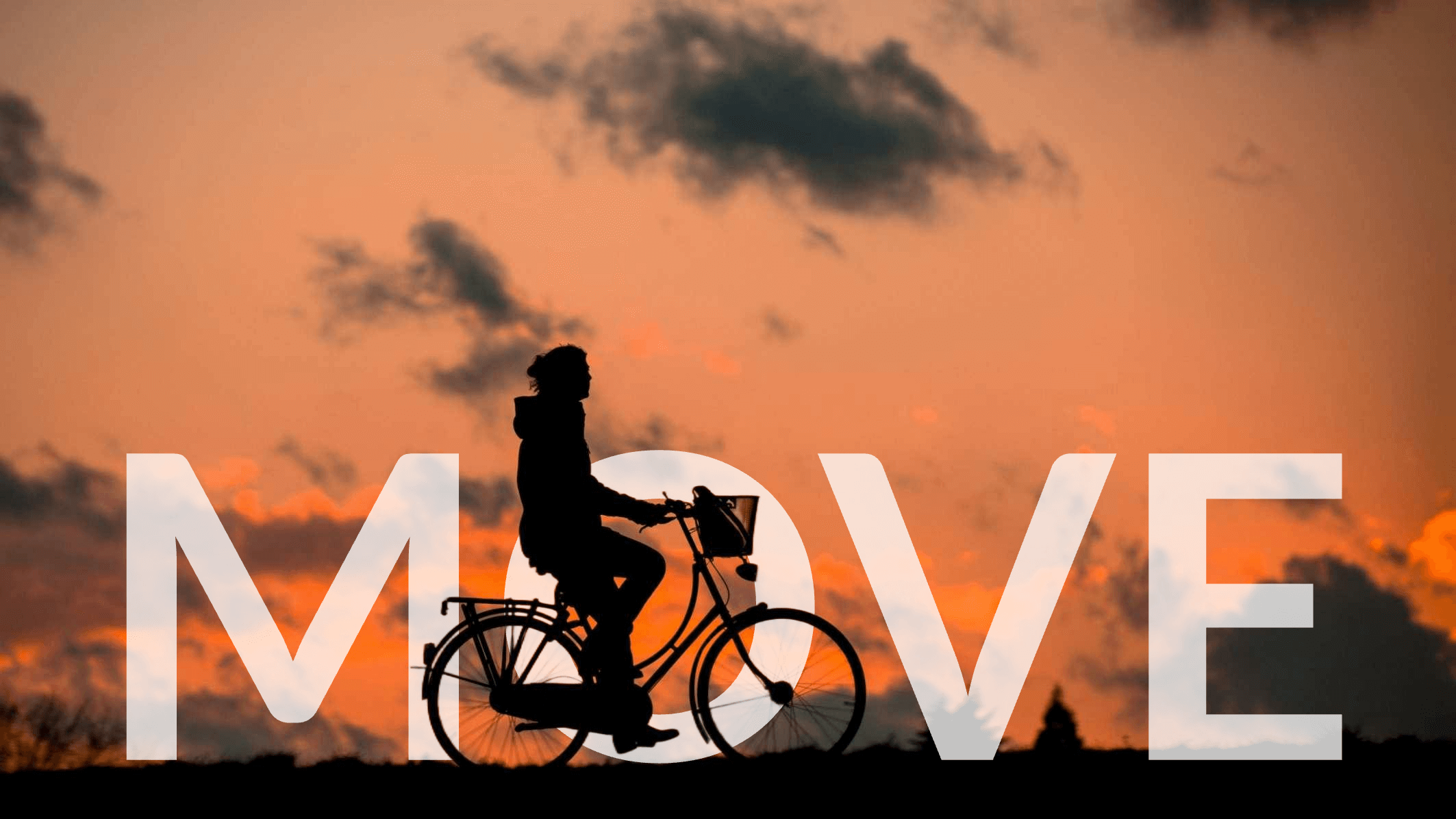 A silhouette of a person riding a bicycle